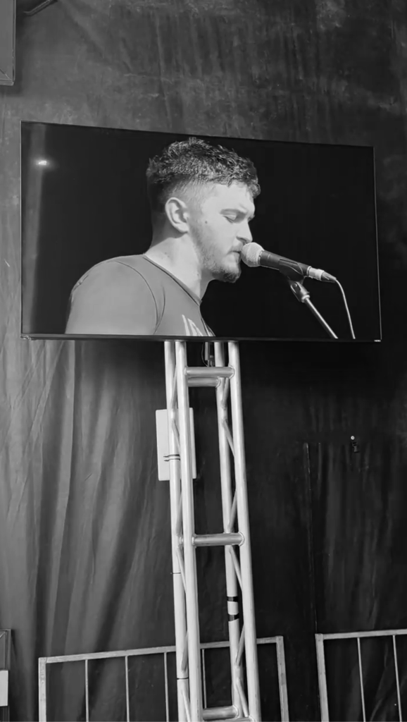 Nic Hitchens performing with a band.