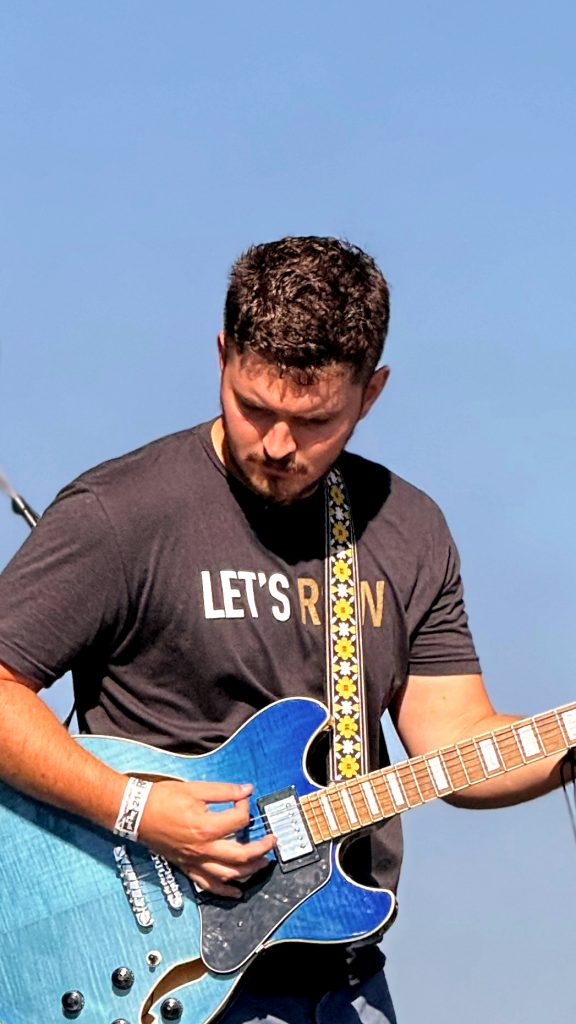Close photograph of Nic Hitchens performing.